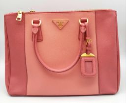 A Prada Two-Tone Pink Galleria Bag. Saffiano leather exterior. Features expandable side wings with