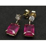 A Pair of 14K Yellow Gold Ruby and Diamond Earrings. 0.24ctw of round cut diamonds. 2ctw of