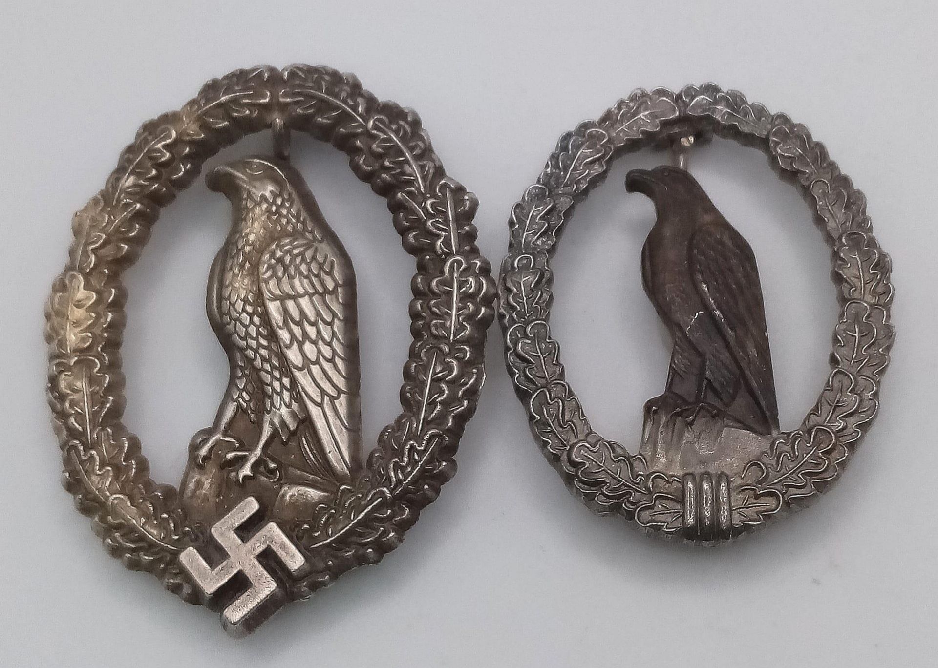 A WW2 German Retired Pilots Badge with a smaller 1957 version without the Swastika, so it could be