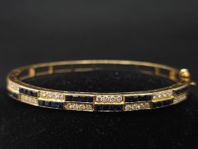 An18kt Yellow Gold Diamond & Sapphire Bangle.0.50ct Diamonds 0.65ct Sapphires W: 13.7g