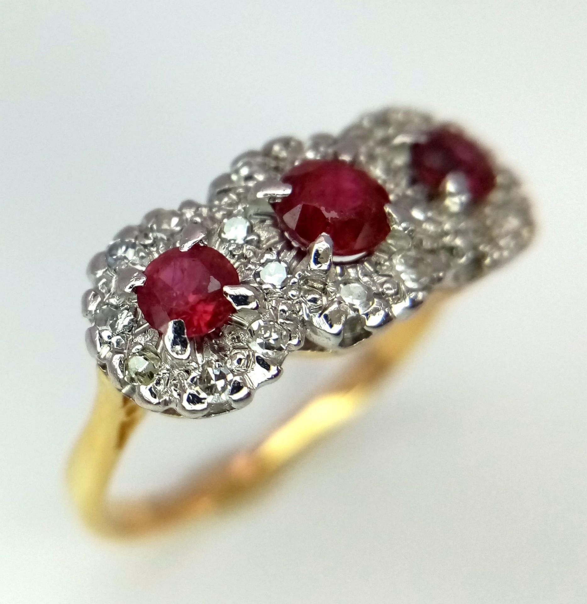 18K YELLOW AND WHITE GOLD DIAMOND & RUBY TRIPLE CLUSTER RING, WITH TRILOGY RUBY SETTING AND DIAMONDS