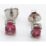 A pair of pink tourmaline stud earrings set in silver.