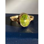 Beautiful 9 carat GOLD and PERIDOT RING, Having an oval cut Peridot set to top in a full walled