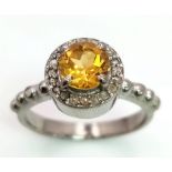 A 1.5CT Citrine with 0.22CT Rose cut Diamonds set in a 925 silver ring. Total weight 3.9G. Size N.