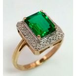 A 9 K yellow and white gold ring with an emerald cut synthetic, flawless emerald. Fully British