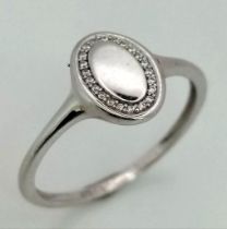 A 9K White Gold Oval Diamond Set Signet Ring. Size N. 0.11ct, 1.4g total weight.