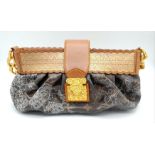 A Louis Vuitton Dentelle 'Kristen' Bag. Monogram leather exterior with intricate lace detailing.
