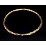 A 9K GOLD TWIST BANGLE . 3.8gms 7cms DIAMETER