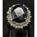 An 8.6ct Blue Sapphire Ring with a Halo of Diamonds on 925 Silver. Size L/M. Approximately 1ctw