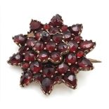 An Antique Garnet Floral Brooch set in Yellow Metal. 22mm.