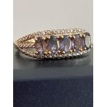 A magnificent TANZANITE RING with five nice size Oval Cut Tanzanite gemstones mounted to top with