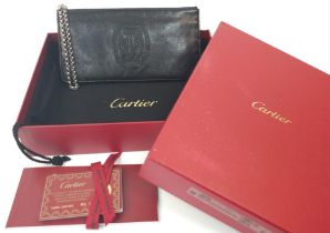 A Cartier Black 'Marcello de Cartier' Clutch Bag. Leather exterior with the Cartier logo stitched,