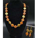 An elegant and sophisticated, carved carnelian and vermeil necklace and earrings set . Necklace