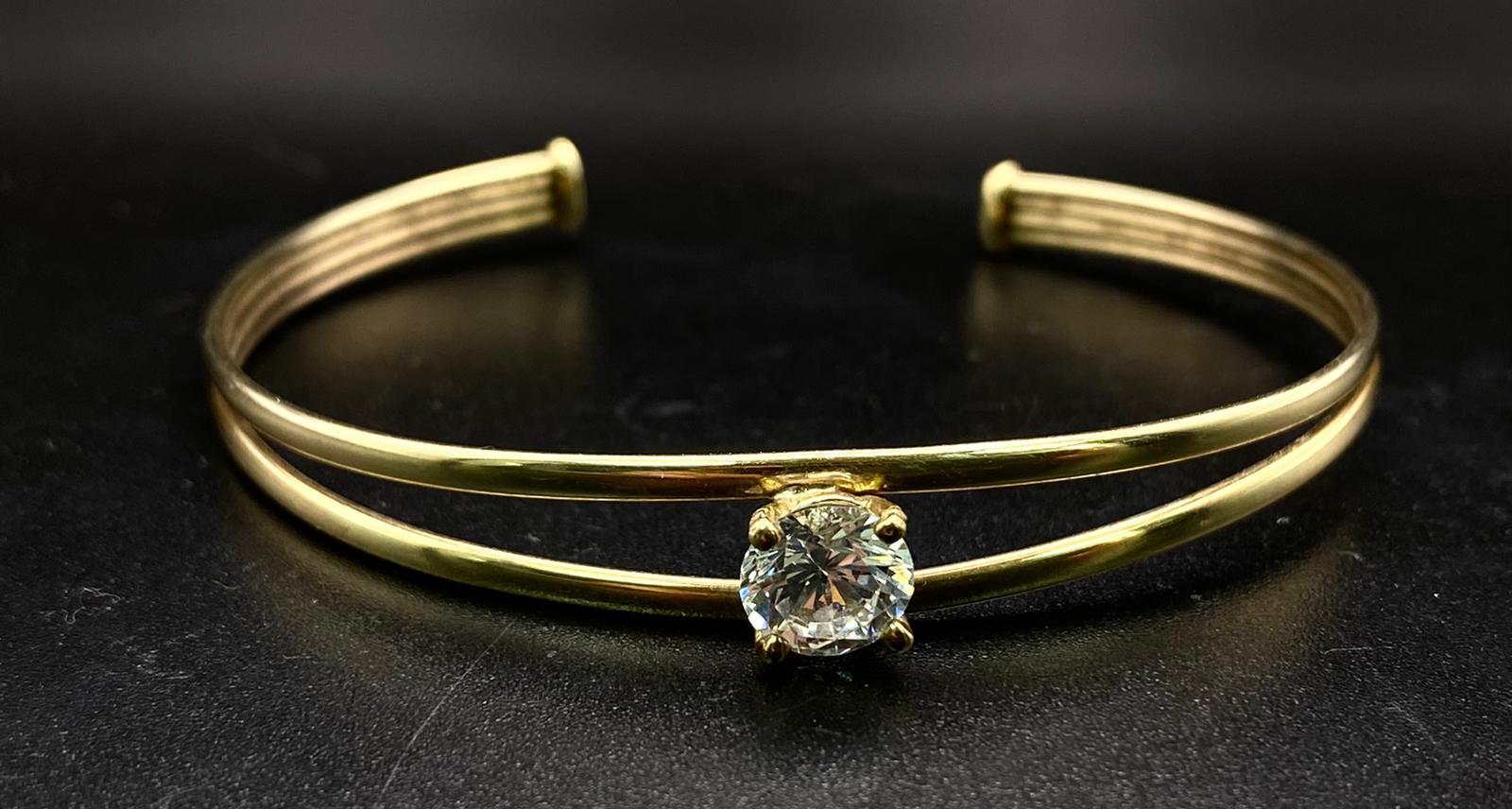 A PRETTY TWIN BAND BANGLE WITH LARGE ZIRCONIA CENTRAL STONE . 4.2gms