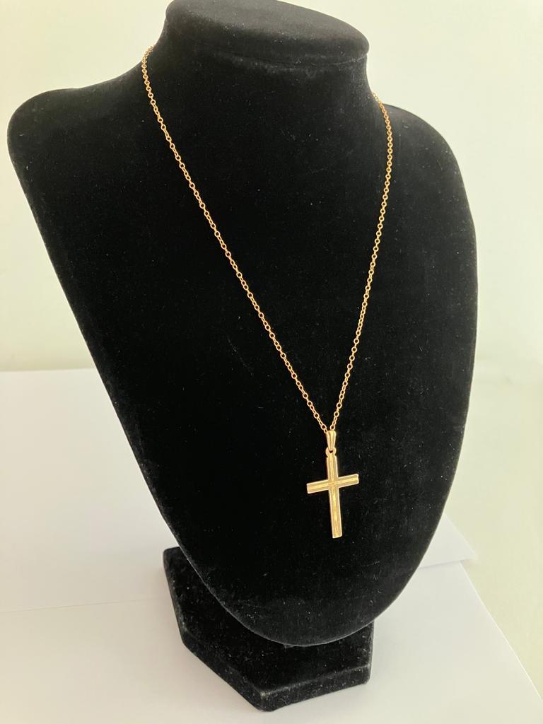 A vintage 9 carat YELLOW GOLD CROSS and CHAIN. Both pieces having full UK hallmark. Gold cross 3.5
