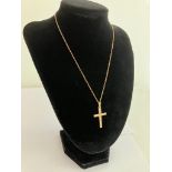 A vintage 9 carat YELLOW GOLD CROSS and CHAIN. Both pieces having full UK hallmark. Gold cross 3.5