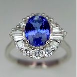 An 18K white gold AA tanzanite and diamond ring. Oval tanzanite - 1.26ct. Round brilliant cut and