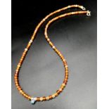 A Coralline Small Bead Necklace with Blue Diamond Decoration. 0.07ct blue diamond. 42cm necklace