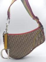 A Christian Dior Rasta Saddle Shoulder Bag. Tan and brown monogram canvas with red piping