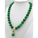 A Green Jade Bead Necklace with Hanging Pendant. Gilded accents and clasp. 12mm beads. 44cm necklace