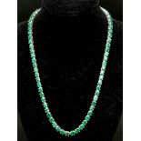 An Emerald Gemstone Tennis Necklace on 925 Silver. Approximately 47cm in length, 34g total weight.