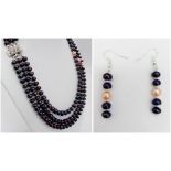 A three strand necklace with high quality black Tahitian pearls and pink pearl accents accompanies