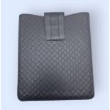 A Gucci Navy Blue iPad Case. Monogram leather exterior with a velcro flap closure. Navy blue suede