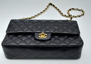 A Classic Chanel Double Flap Bag. Quilted lambskin black leather exterior with gilded Chanel logo
