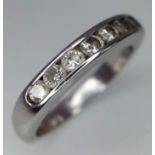 An 18K White Gold Seven Stone Diamond Ring. Seven round cut diamonds. Size L. 4.2g total weight.