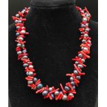 A fabulous, two strand necklace with quality black Tahitian pearls and genuine red corals.