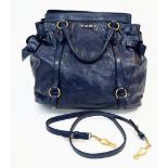 A Miu Miu Blue Leather Handbag with Adjustable Shoulder Strap. Gilded furniture with exterior zipped