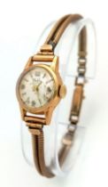 A Vintage 18K and 9K Gold Mudu Ladies Watch. 9k gold parallel bracelet. 18k gold case - 16mm.