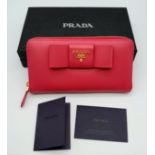 A Prada Pink Bow Purse/Wallet. Saffiano leather exterior. It features two main compartments, a