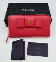 A Prada Pink Bow Purse/Wallet. Saffiano leather exterior. It features two main compartments, a