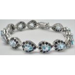 A gorgeous 925 silver Blue Topaz Bracelet with Natural Blue Sapphire Surrounding. Total weight 25.