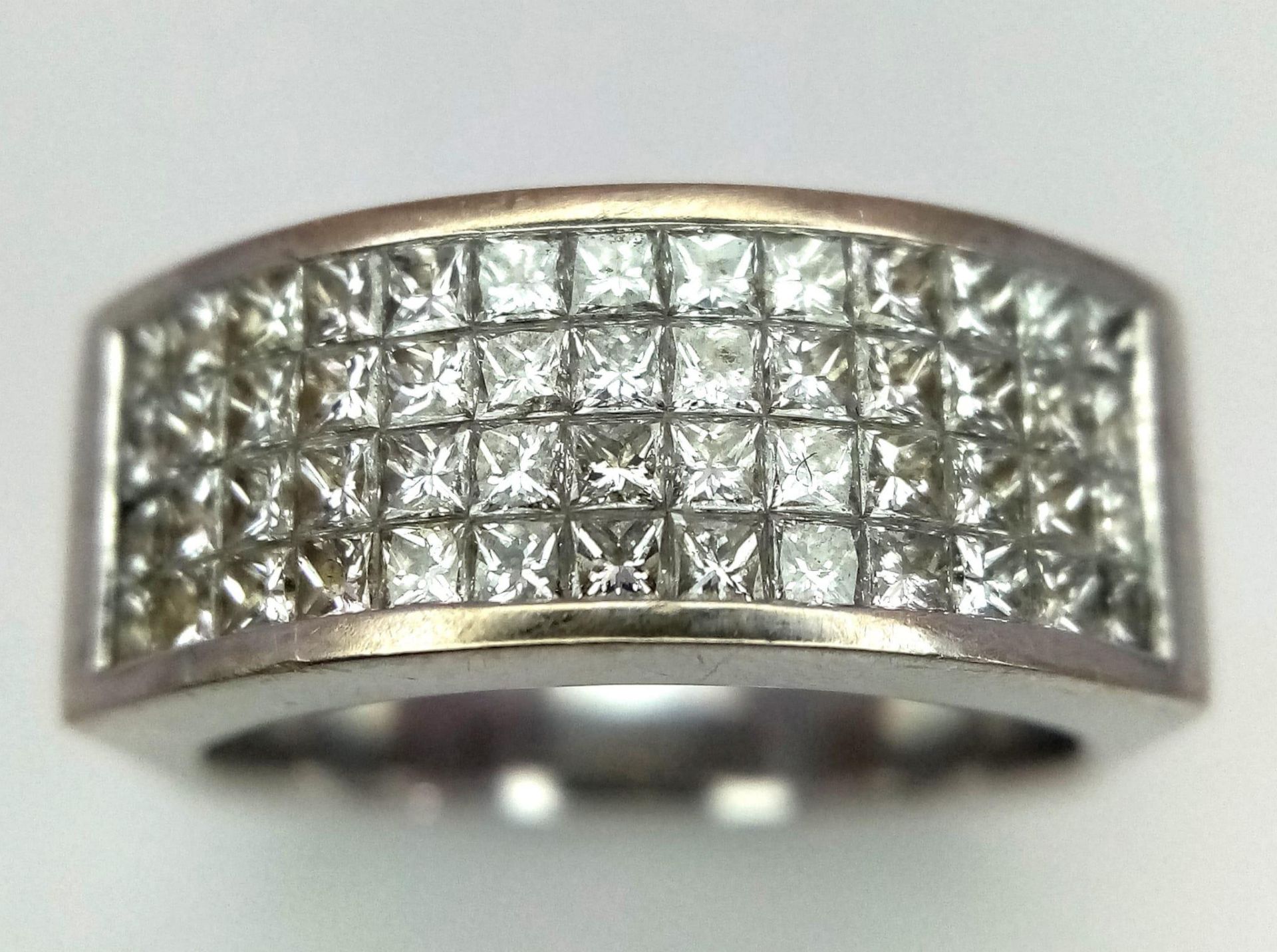 An 18 K white gold ring with four diamond bands. Size: P, weight: 12.3 g. 14272
