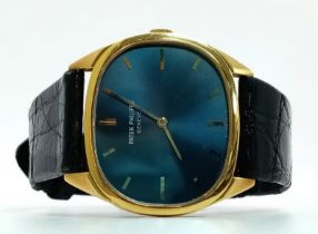A Vintage Patek Philippe 18K Gold Watch. Black leather strap - 18k gold buckle. 18k gold case -