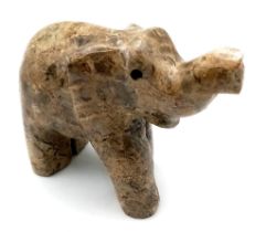 A VARNISHED NATURAL SANDSTONE ELEPHANT FIGURE . 192gms 7cms tall .