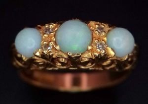 An 18K Yellow Gold Opal and Diamond Ring. Three iridescent opals - 0.8ctw approx with diamond