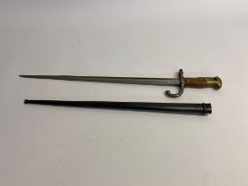 An 1874 Gras Rifle Bayonet and Scabbard. Inscription on the spine of the blade and dated 1878.