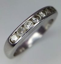 An 18K White Gold Seven Stone Diamond Ring. Seven round cut diamonds. Size L. 4.2g total weight.