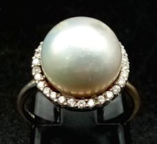 A SOUTH SEA PEARL RING SURROUNDED BY A HALO OF QUALITY DIAMONDS AND SET IN 18K WHITE GOLD .3.7gms