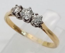 AN 18K YELLOW GOLD DIAMOND TRILOGY RING. Size P, 0.35ctw, 2g total weight.