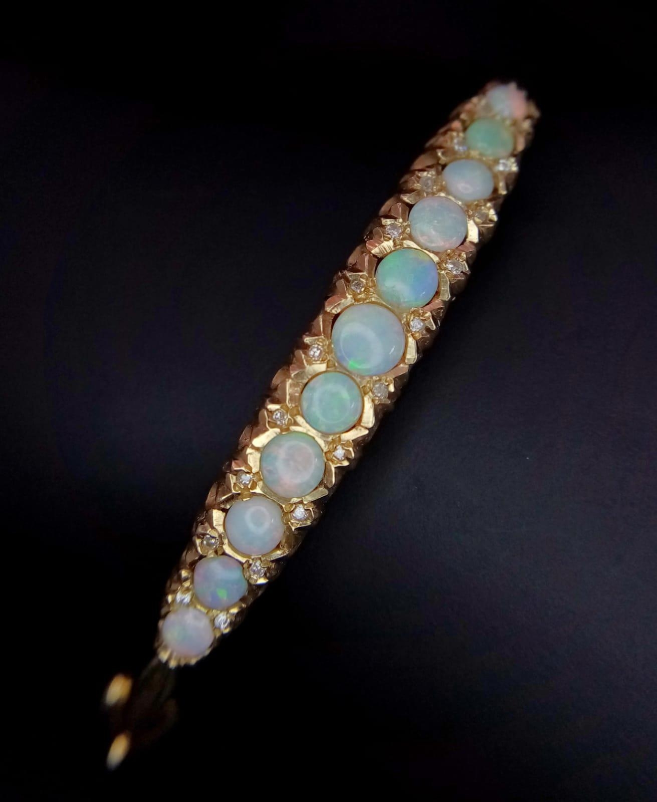 A Beautifully Made 9K Yellow Gold, Opal and Diamond Hinged Bracelet. Eleven opal graduating - Image 2 of 5