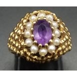 A Beautiful Vintage 9K Yellow Gold, Amethyst and Seed Pearl Ring. Central clean oval cut amethyst