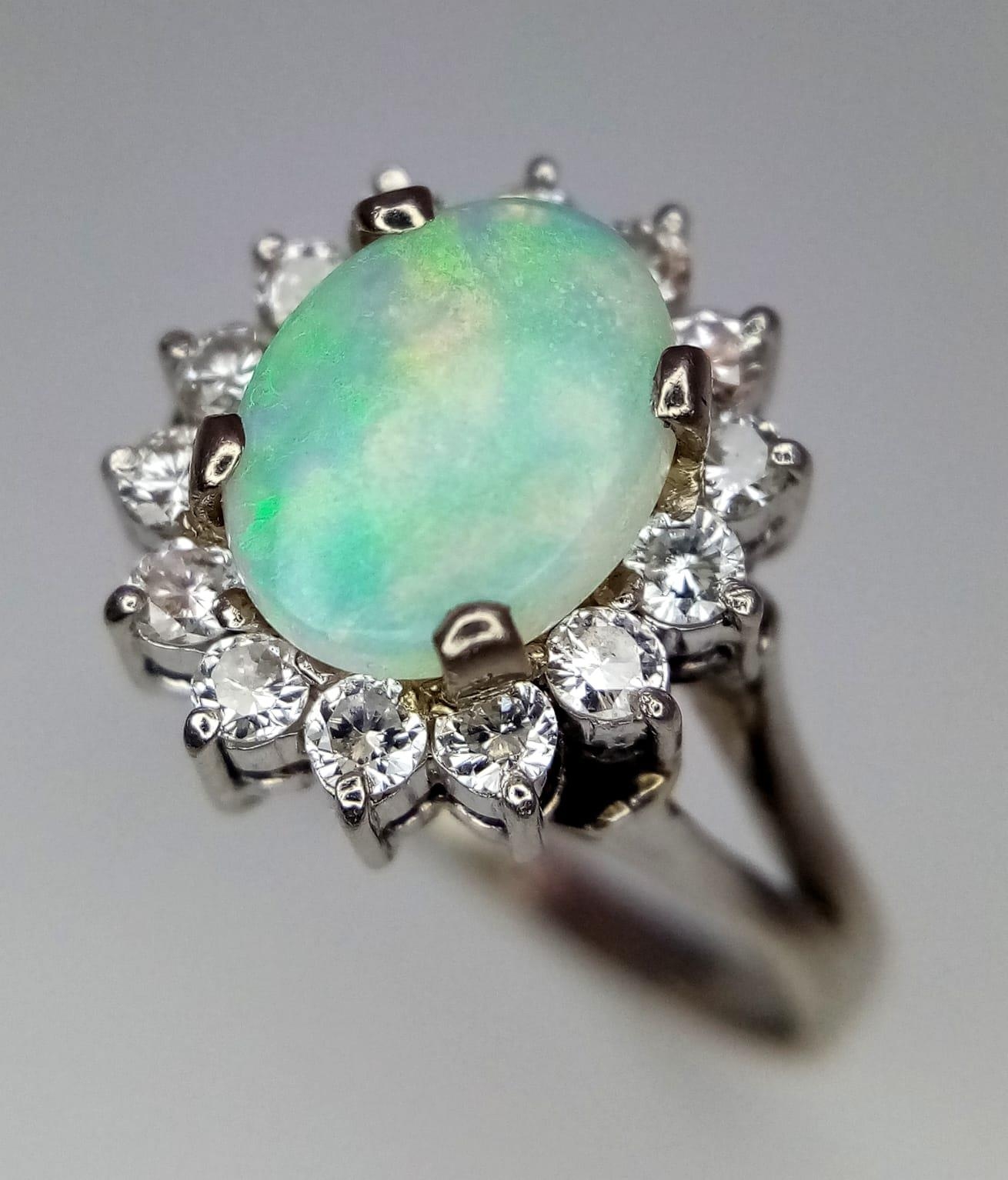 An 18K White Gold (tested) Opal and Diamond Ring. Central oval opal cabochon - 1ct approx, - Image 2 of 9