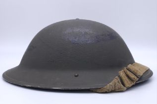 1943 Dated British MK II Helmet. Original Paint. Makers Marked RO & CO. With original chin strap.