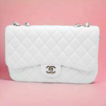 An exquisite Chanel White Caviar Classic Flap Bag. The interior is lined in a tonal leather, care