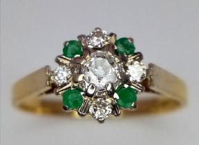 A 9k Yellow Gold Emerald and Diamond Decorative Floral Ring. Size M. 2.14g total weight.