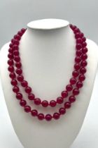 A Matinee Length Red Jade Bead Necklace. 10mm beads. Necklace length - 84cm.